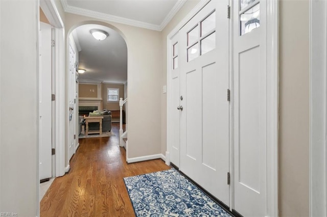 foyer entrance featuring light hardwood / wood-style floors and crown molding