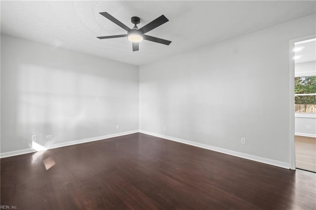 empty room featuring dark hardwood / wood-style floors and ceiling fan