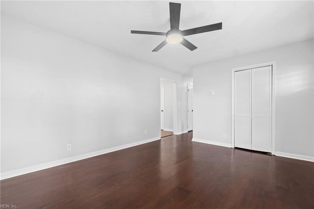 unfurnished bedroom with dark hardwood / wood-style flooring, a closet, and ceiling fan