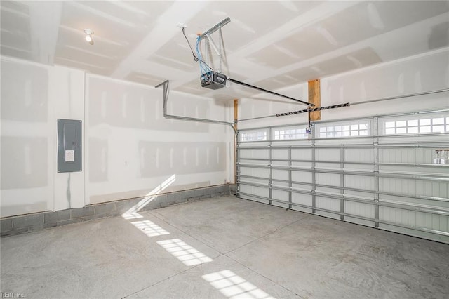 garage featuring electric panel and a garage door opener