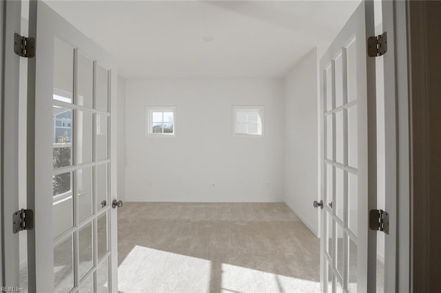 empty room featuring light colored carpet