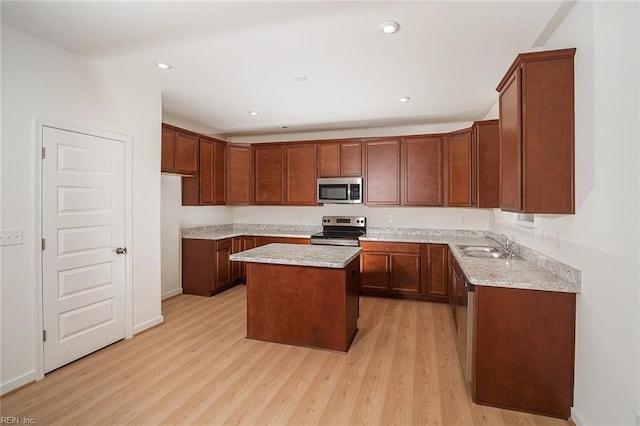 kitchen featuring a center island, light hardwood / wood-style flooring, stainless steel appliances, and sink