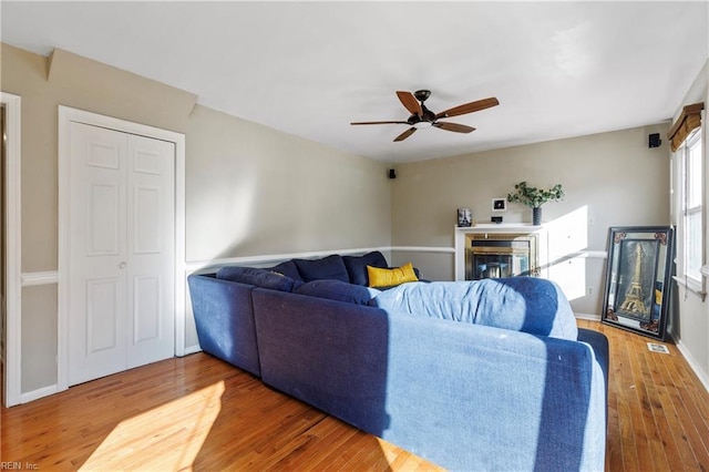 living room with hardwood / wood-style flooring and ceiling fan