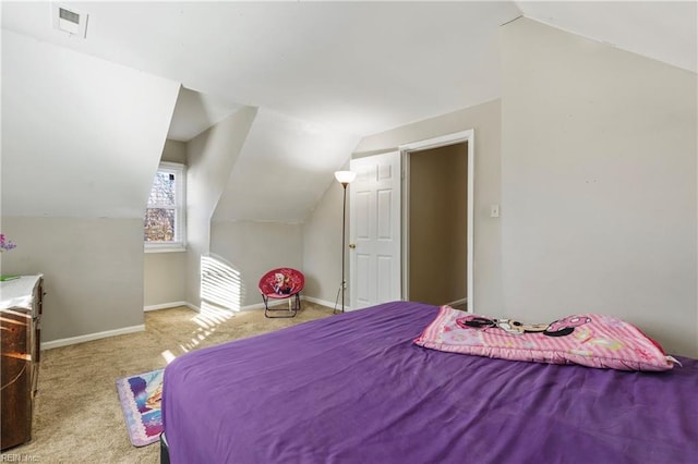 bedroom featuring light carpet and vaulted ceiling