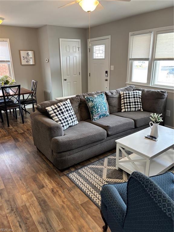 living room with ceiling fan, a healthy amount of sunlight, and dark hardwood / wood-style floors