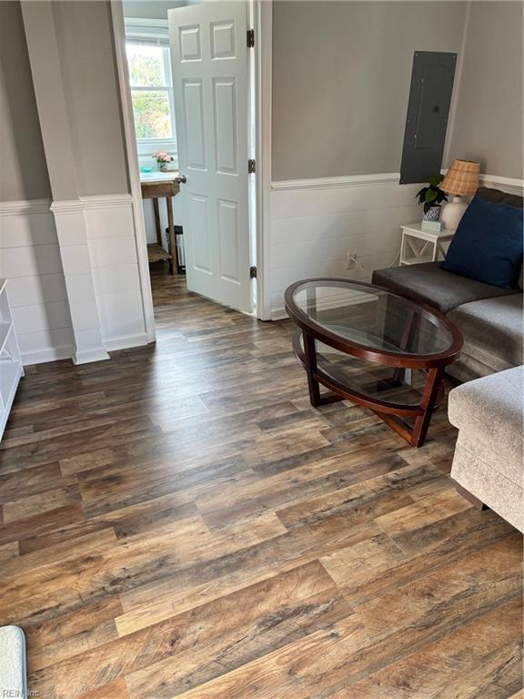 living room featuring electric panel and dark wood-type flooring