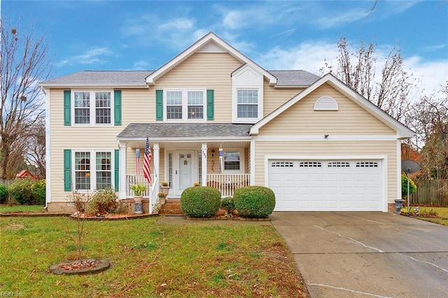 view of front facade with a garage, a porch, and a front yard