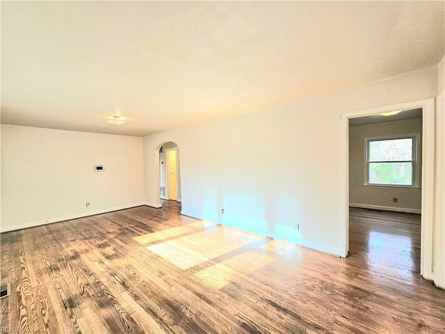 empty room with hardwood / wood-style flooring