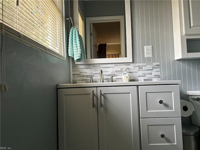 bathroom featuring backsplash, vanity, and toilet