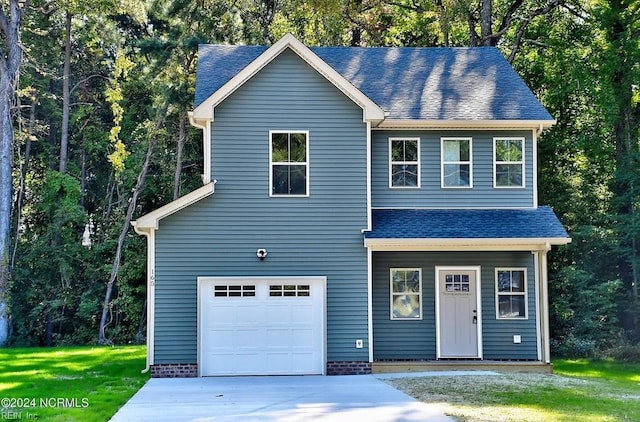 view of front of home featuring a garage and a front lawn