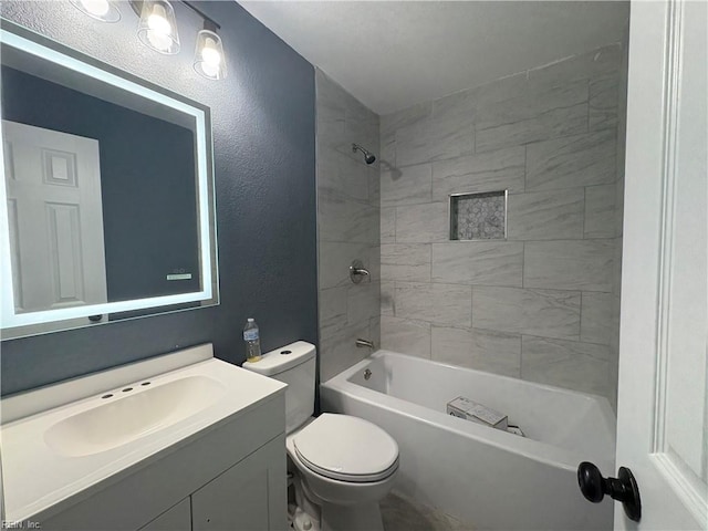 full bathroom with vanity, toilet, and tiled shower / bath combo