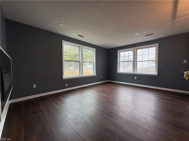 spare room with dark hardwood / wood-style floors