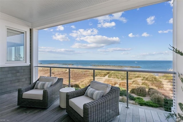 wooden terrace with a water view and a view of the beach