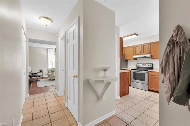 kitchen featuring light tile patterned flooring and appliances with stainless steel finishes