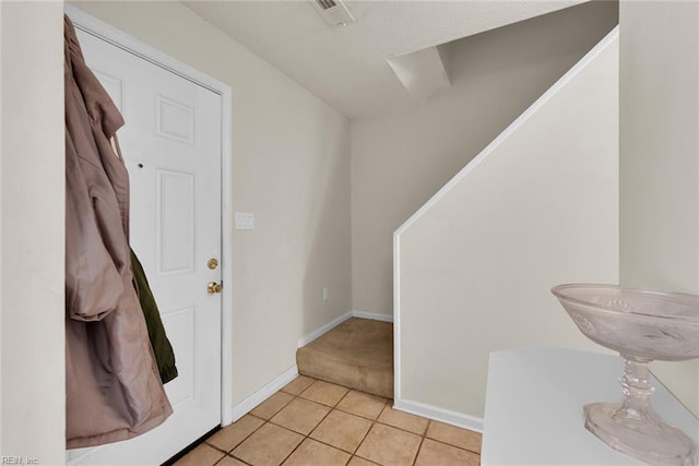 foyer entrance featuring light tile patterned flooring