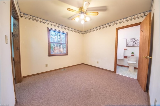 unfurnished bedroom with ensuite bath, ceiling fan, and light colored carpet