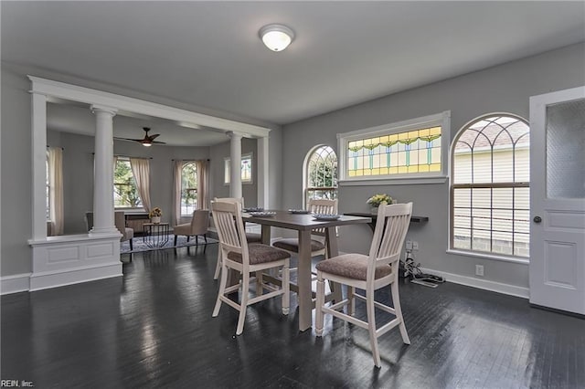 dining space featuring ceiling fan, dark hardwood / wood-style flooring, and ornate columns