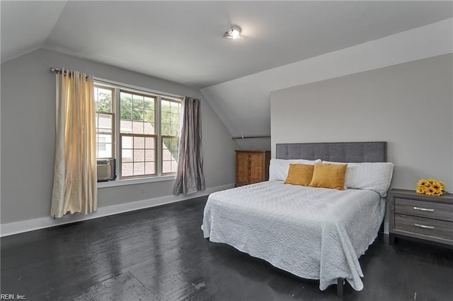 bedroom featuring dark hardwood / wood-style flooring, cooling unit, and lofted ceiling