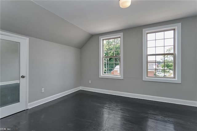 bonus room featuring dark hardwood / wood-style flooring and vaulted ceiling