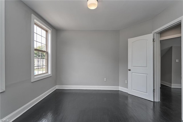 spare room with dark hardwood / wood-style floors