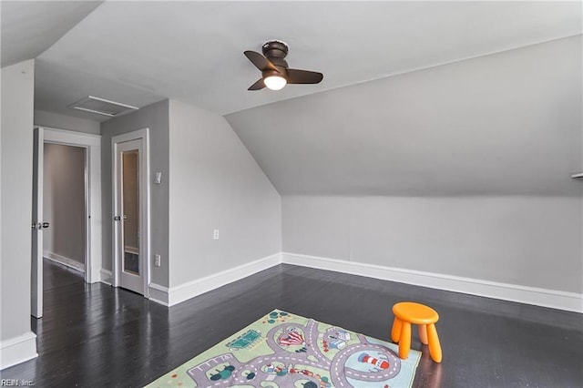 interior space with ceiling fan, dark hardwood / wood-style floors, and vaulted ceiling