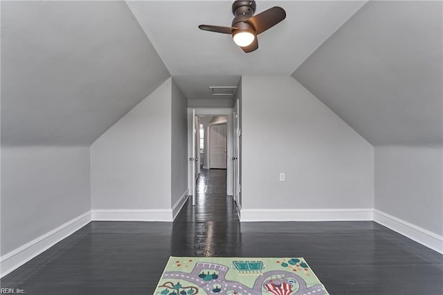 bonus room featuring dark hardwood / wood-style flooring, ceiling fan, and lofted ceiling