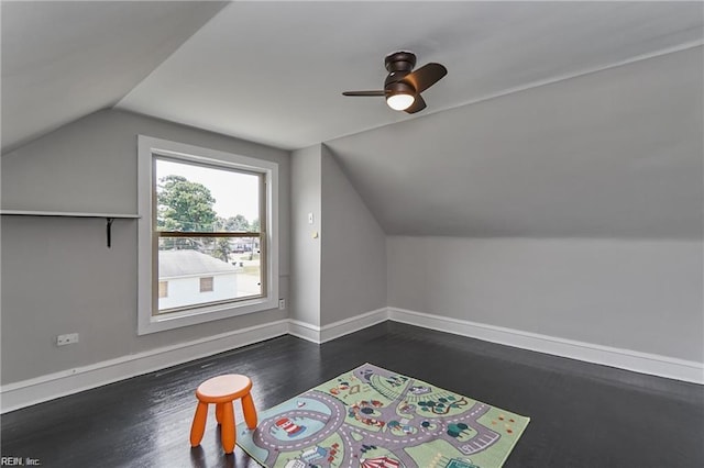 bonus room with ceiling fan, dark wood-type flooring, and vaulted ceiling