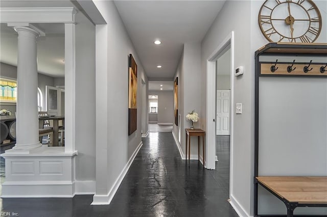 hallway featuring decorative columns and a healthy amount of sunlight