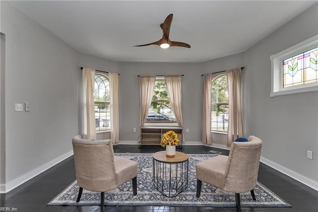 sitting room featuring ceiling fan and dark wood-type flooring