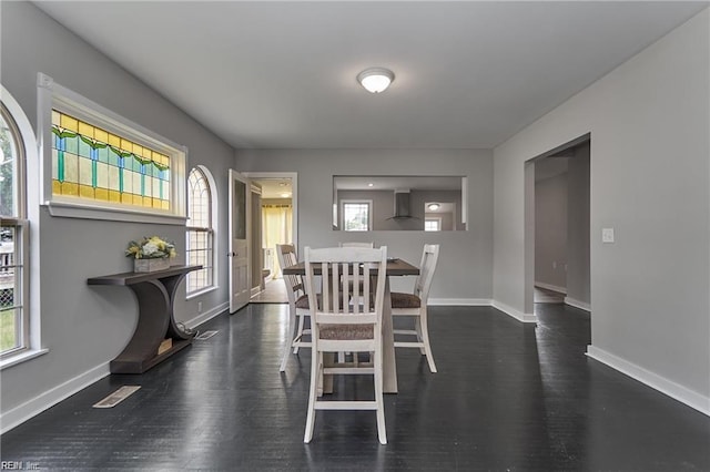 dining area with dark wood-type flooring