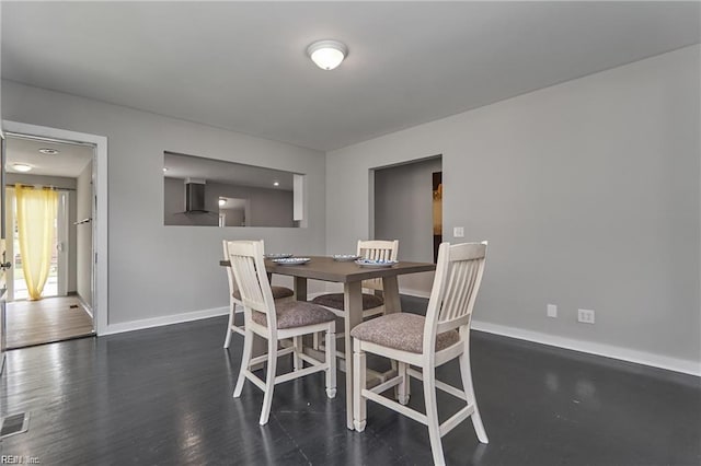 dining area with dark hardwood / wood-style flooring