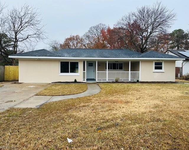 ranch-style home with a front yard and a porch