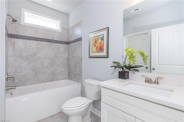 full bathroom with toilet, vanity, and tiled shower / bath combo