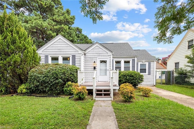 bungalow-style home featuring a front yard