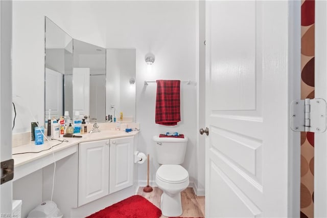 bathroom featuring hardwood / wood-style flooring, vanity, and toilet