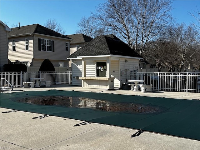 view of swimming pool with an outdoor structure and a patio