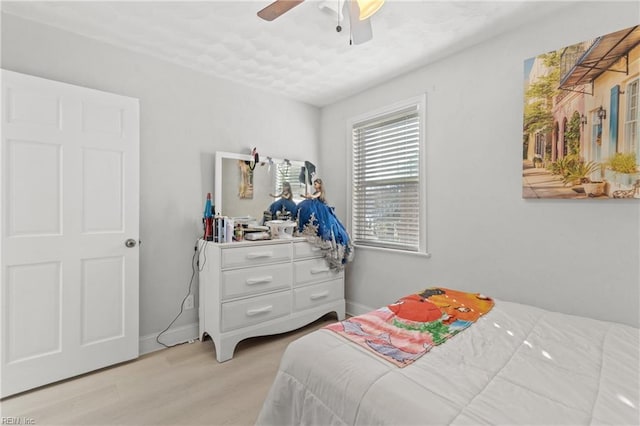 bedroom featuring ceiling fan and light hardwood / wood-style flooring