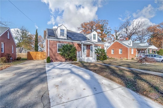 new england style home featuring solar panels