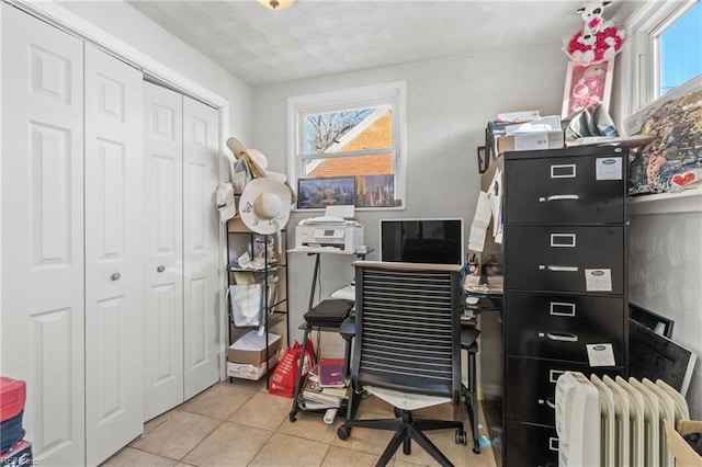 office area with radiator heating unit and light tile patterned floors