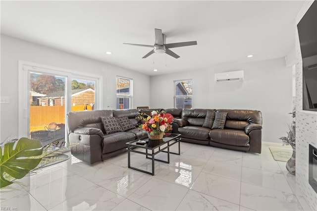 living room with ceiling fan, an AC wall unit, and a fireplace