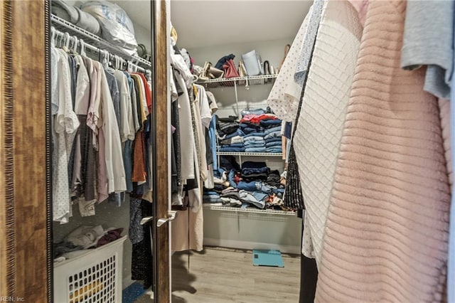 walk in closet featuring light hardwood / wood-style flooring