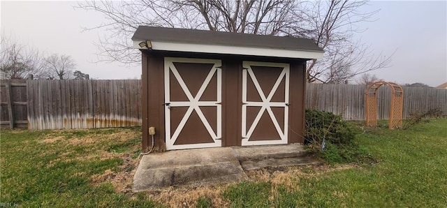 view of outdoor structure featuring a lawn