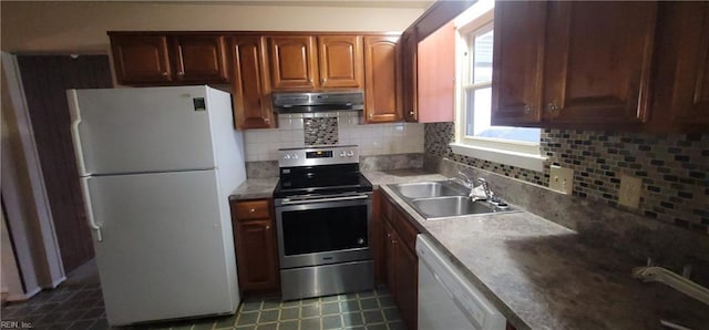 kitchen featuring white appliances, tasteful backsplash, and sink