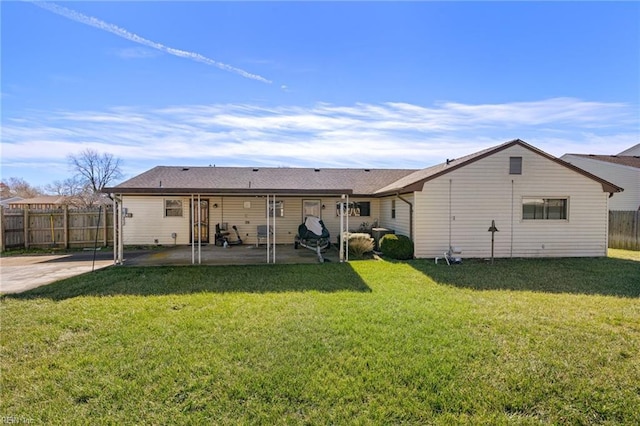 rear view of property featuring a patio and a yard