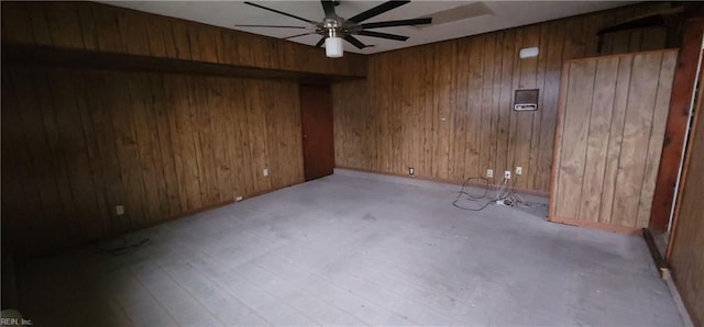 spare room with wood walls, ceiling fan, and light hardwood / wood-style flooring