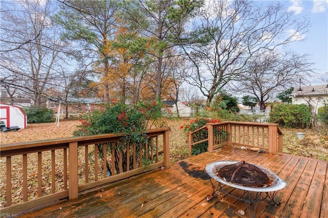 wooden deck featuring a fire pit