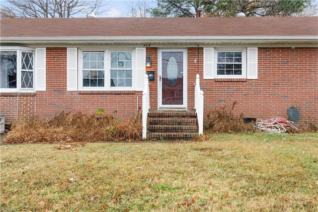 property entrance with a lawn