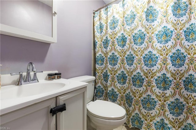 bathroom featuring tile patterned floors, vanity, and toilet