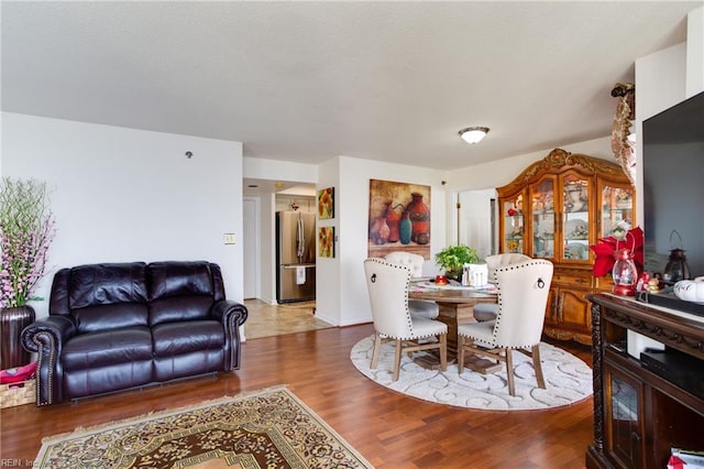 dining space with wood-type flooring