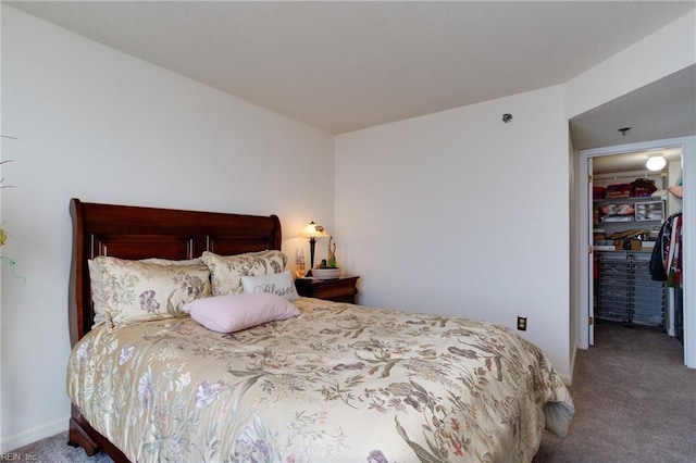 bedroom featuring a closet, a spacious closet, and carpet